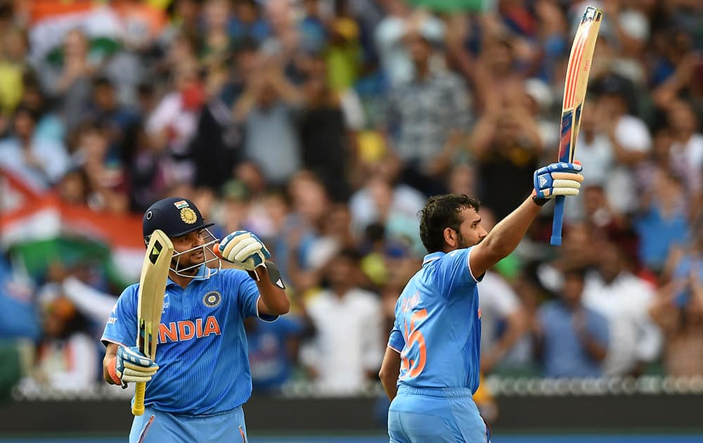 Rohit Sharma, celebrates after scoring a century while batting against Bangladesh as teammate Suresh Raina watches during their Cricket World Cup quarterfinal match in Melbourne, Australia.