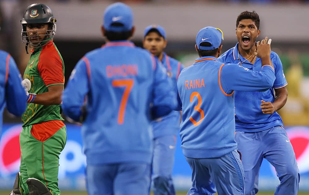 Umesh Yadav, celebrates after taking the wicket of Bangladesh’s Tamim Iqbal, during their Cricket World Cup quarterfinal match in Melbourne.