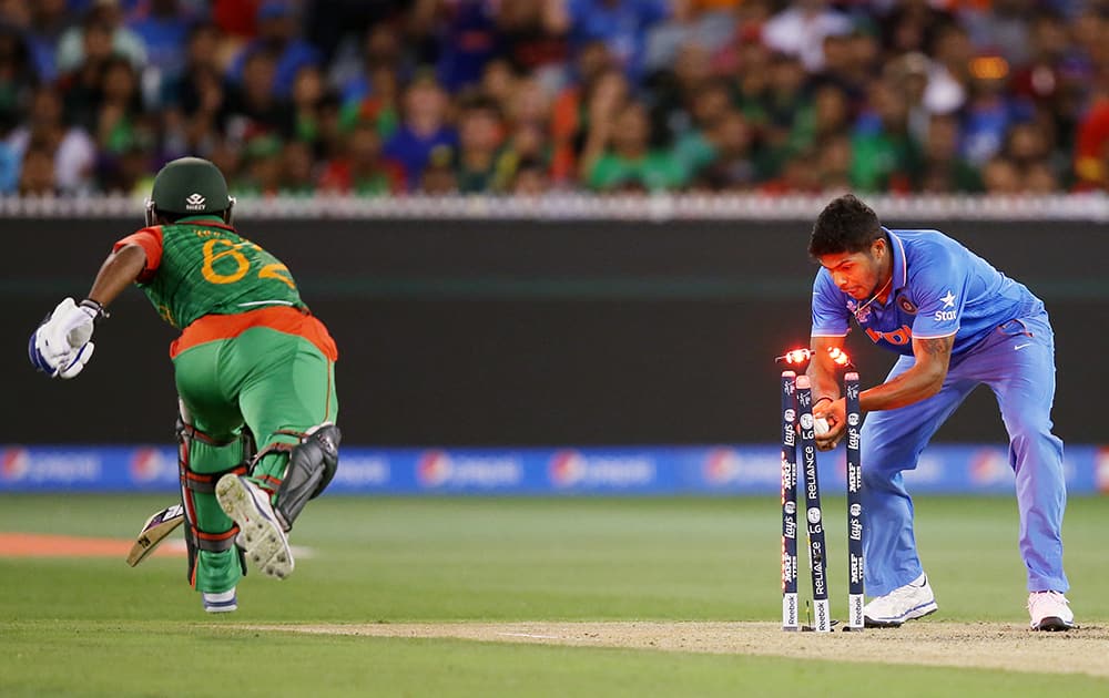 Umesh Yadav, runs out Bangladesh's Imrul Kayes during their Cricket World Cup quarterfinal match in Melbourne, Australia.