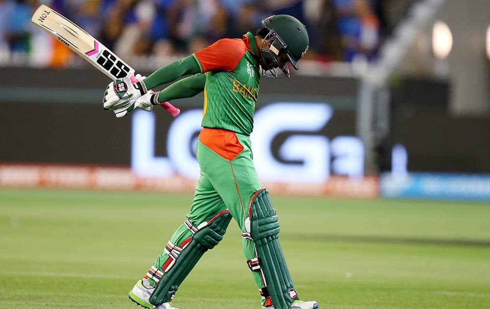 Bangladesh’s Mushfiqur Rahim walks from the field after he was dismissed for 27 runs during their Cricket World Cup quarterfinal match against India in Melbourne.