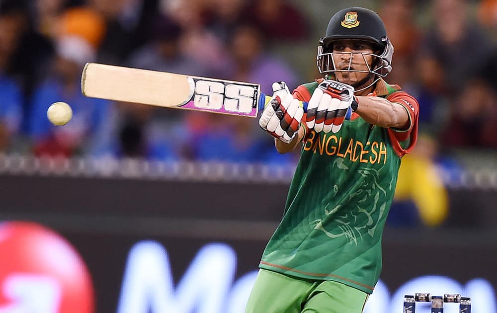 Bangladesh’s Nasir Hossain hits the ball while batting against India during their Cricket World Cup quarterfinal match in Melbourne, Australia.