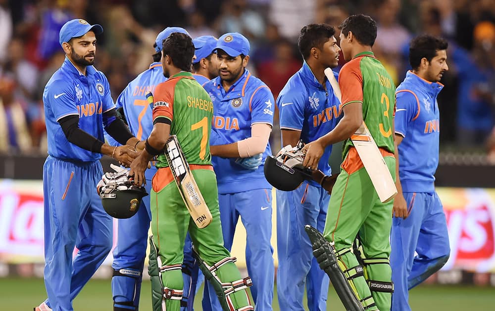 Players are congratulated by Bangladesh’s Shabbir Rahman Roman and Bangladesh’s Taskin Ahmed after winning their Cricket World Cup quarterfinal by 109 runs in Melbourne, Australia.