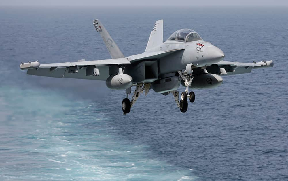 A US military plane approaches to land on the flight deck of the USS Carl Vinson aircraft carrier in the Persian Gulf.