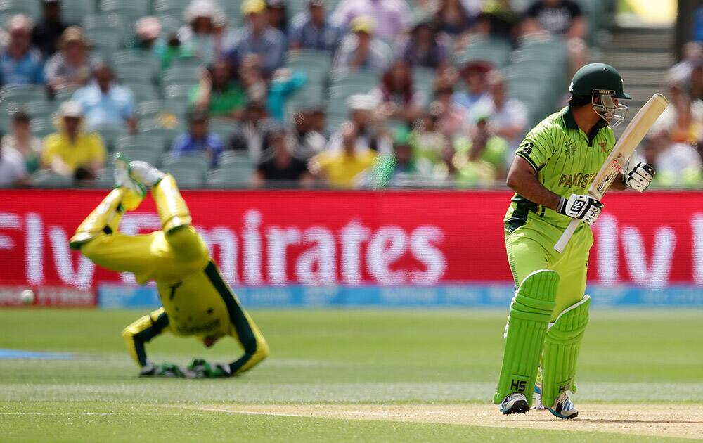 Pakistan's Sarfaraz Ahmed plays a shot as Australia's wicketkeeper Brad Haddin dives in to catch the ball during their Cricket World Cup quarterfinal match in Adelaide, Australia.