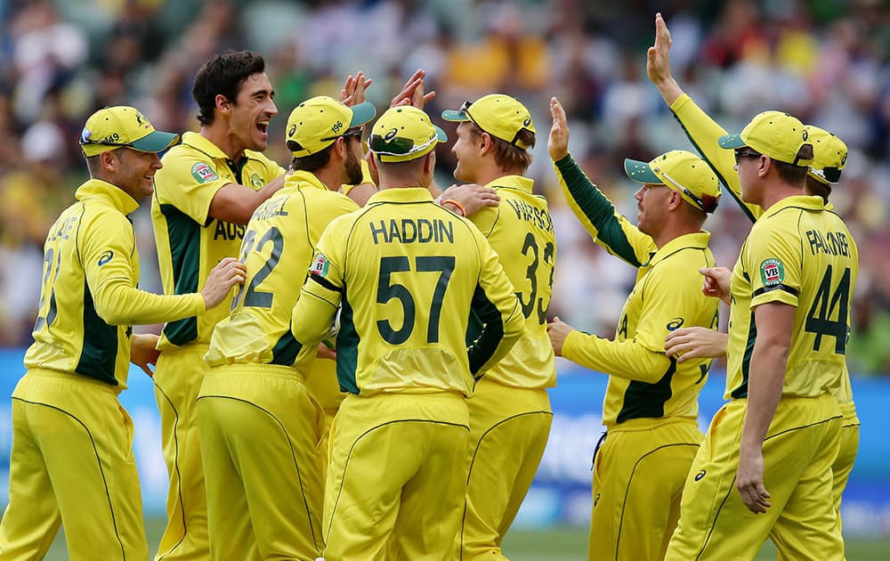 Australian players congratulate Mitchell Starc, second left, after he took the wicket of Pakistan's Sarfaraz Ahmed during their Cricket World Cup quarterfinal match in Adelaide, Australia.