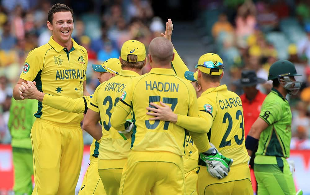 Australia's Josh Hazlewood, left, celebrates celebrates with his teammates after taking the wicket of Pakistan's Ahmad Shahzad during their Cricket World Cup quarterfinal match in Adelaide.