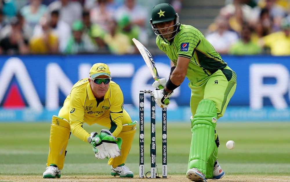 Pakistan's captain Misbah Ul Haq looks to play a shot as Australia's wicketkeeper Brad Haddin watches during their Cricket World Cup quarterfinal match in Adelaide.