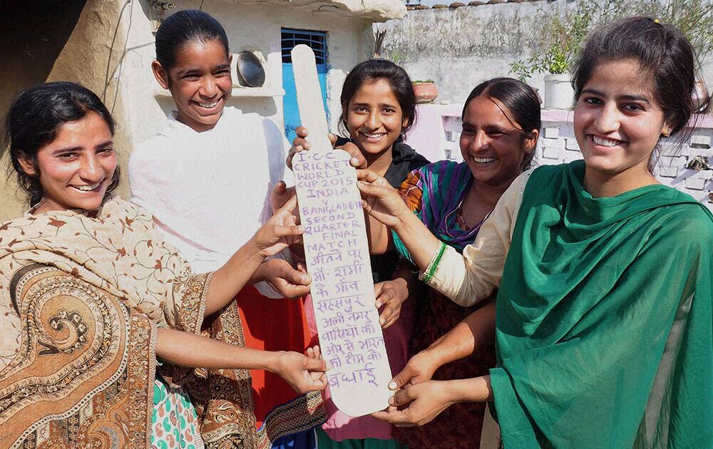 Girls from the village of pacer Mohammed Shami celebrate Team Indias win against Bangladesh in Cricket World Cup, in Moradabad.