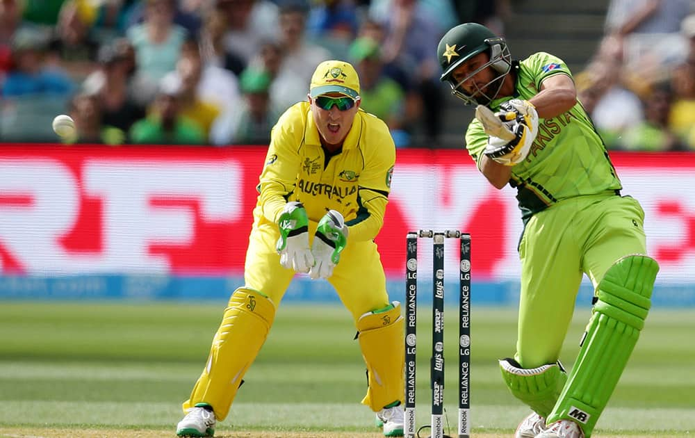 Pakistan's Shahid Afridi hits the ball as Australia's wicketkeeper Brad Haddin watches during their Cricket World Cup quarterfinal match in Adelaide, Australia.