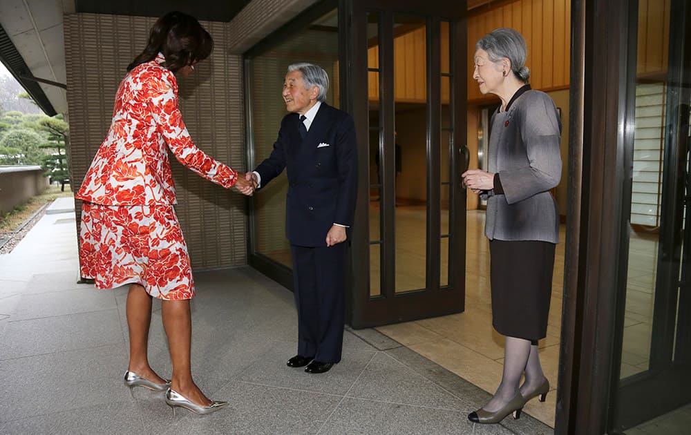US first lady Michelle Obama is greeted by Emperor Akihito and Empress Michiko upon her arrival at the imperial residence in the compound of the Imperial Palace in Tokyo.
