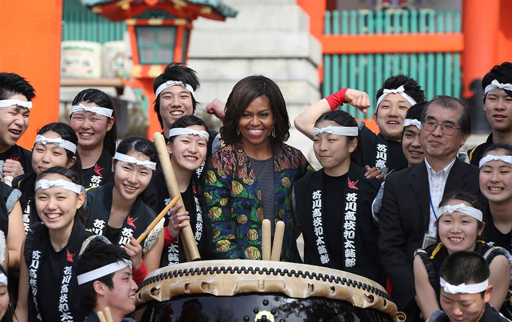 US first lady Michelle Obama poses for a photo with the Akutagawa High School Taiko Club during her visit to Fushimi Inari Shinto Shrine in Kyoto, in western Japan.