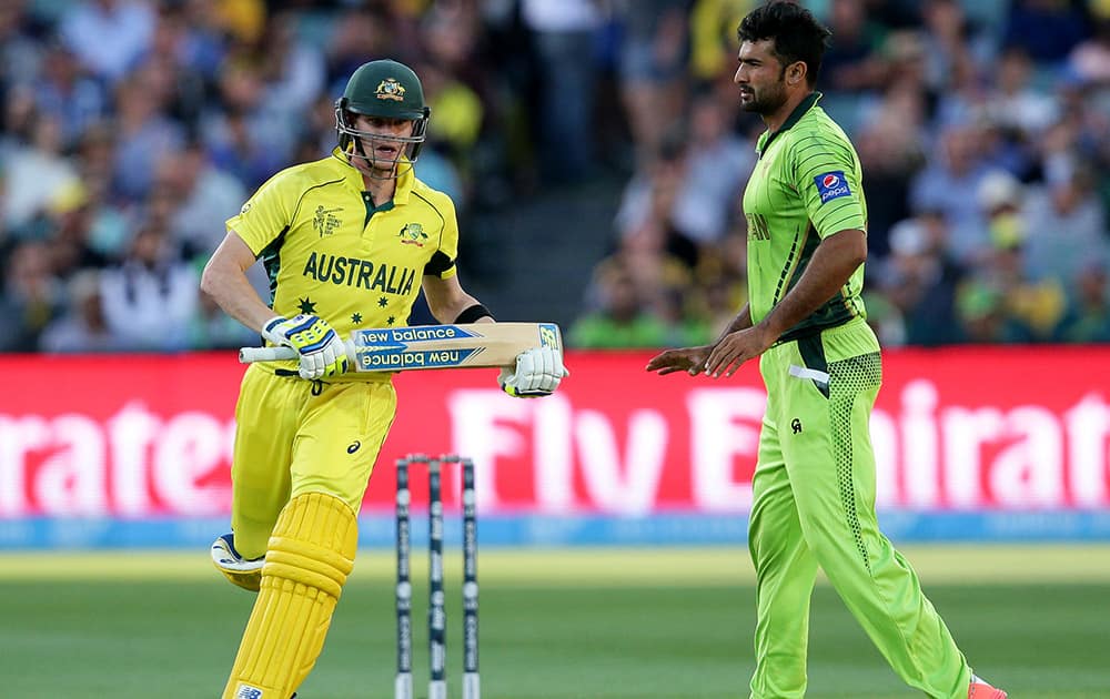 Australian batsman Steve Smith runs around Pakistan's Sohail Khan during their Cricket World Cup quarterfinal match in Adelaide, Australia.