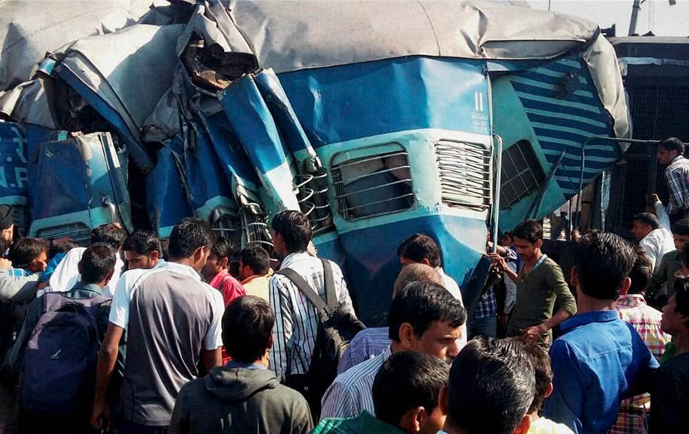 People gather at the accident site after the Dehradun-Varanasi Janata Express derailed at the Bachhrawan railway station in Raebareli.