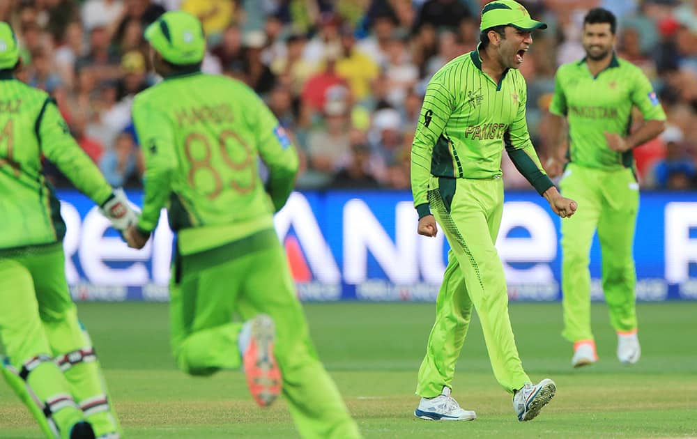 Pakistan's Sohaib Maqsood celebrates with his teammates after taking a catch to dismiss Australia's Michael Clarke during their Cricket World Cup quarterfinal match in Adelaide, Australia.