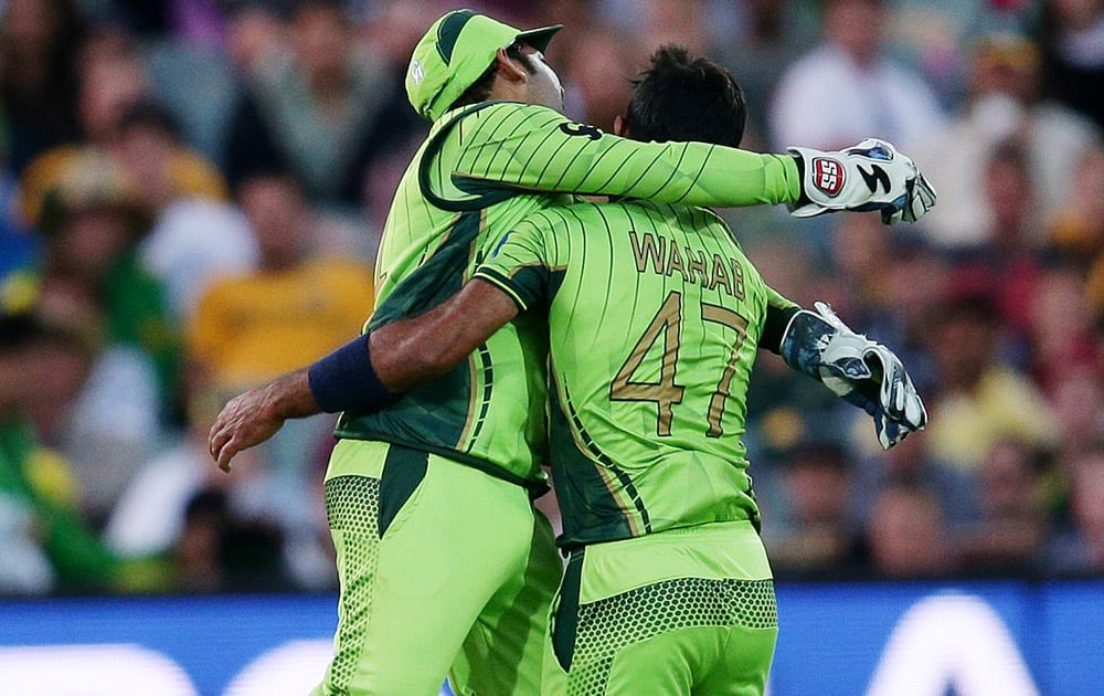 Pakistan's Wahab Riaz celebrates with teammate Sarfaraz Ahmed the dismissal of Australia's Michael Clarke during their Cricket World Cup quarterfinal match in Adelaide, Australia.