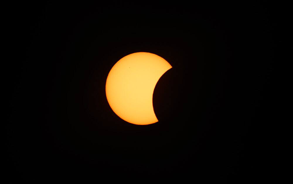 The starts to block the sun during a solar eclipse seen from Svalbard, Norway.