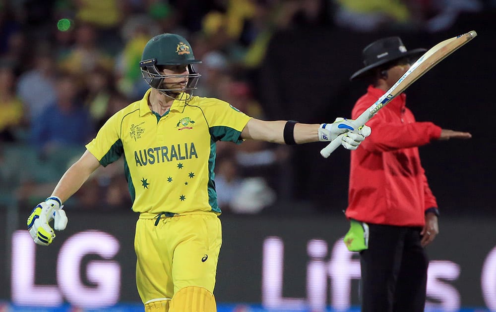 Australia's Steve Smith waves his bat as he celebrates scoring 50 runs during their Cricket World Cup quarterfinal match against Pakistan in Adelaide.