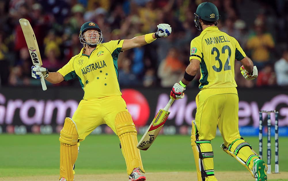 Australia's Shane Watson, celebrates with teammate Glenn Maxwell after they defeated Pakistan by six wickets in their Cricket World Cup quarterfinal match in Adelaide, Australia.