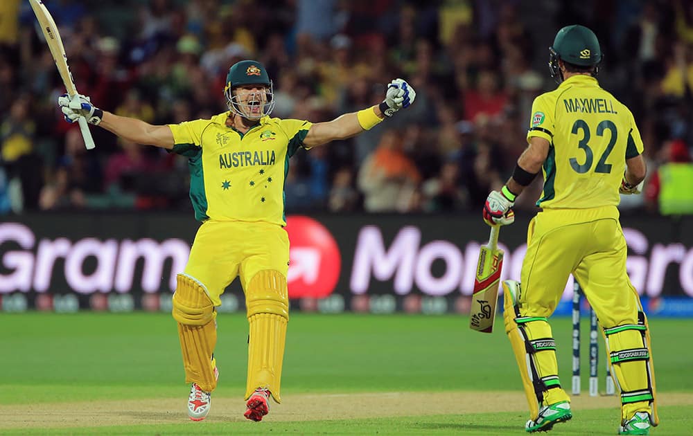 Australia's Shane Watson celebrates with teammate Glenn Maxwell after they defeated Pakistan by six wickets in their Cricket World Cup quarterfinal match in Adelaide, Australia.