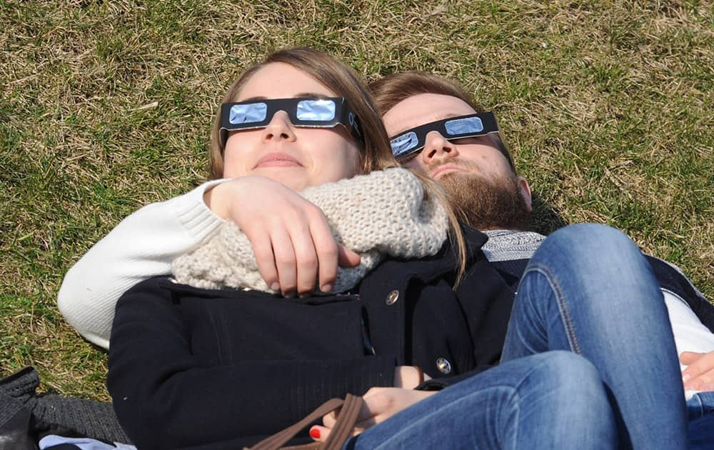 People watch a solar eclipse in Warsaw, Poland.