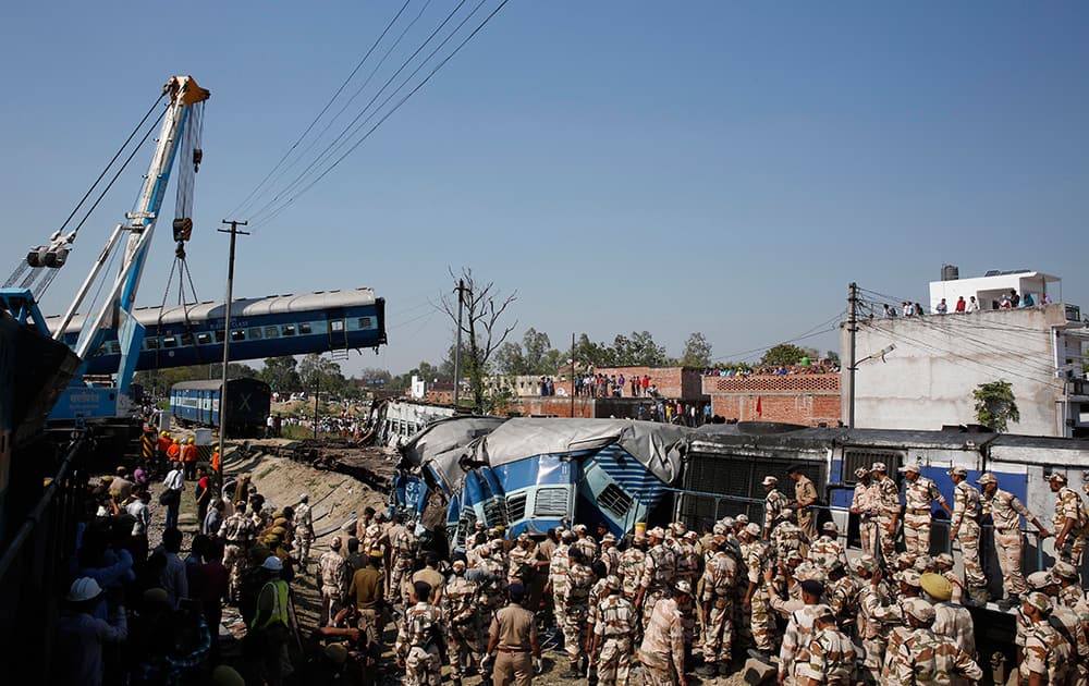 Rescue workers gather at the site of a train accident near Bachhrawan village, Uttar Pradesh.