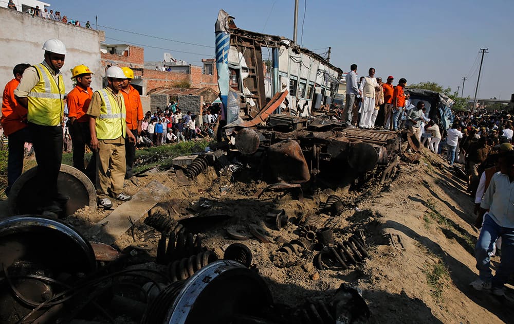 Rescue workers gather at the site of a train accident near Bachhrawan village, Uttar Pradesh