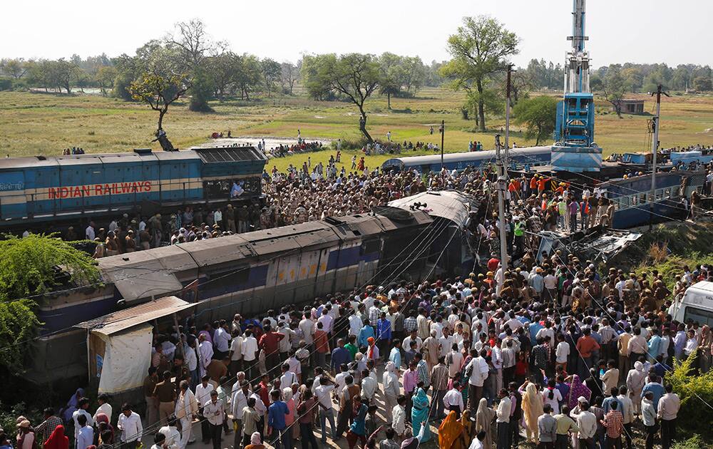 Rescue workers and others gather at the site of a train accident near Bachhrawan village, Uttar Pradesh.