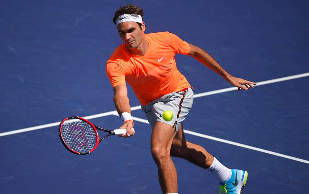 Roger Federer, of Switzerland, returns a volley from to Tomas Berdych, of the Czech Republic, during their match at the BNP Paribas Open tennis tournament.