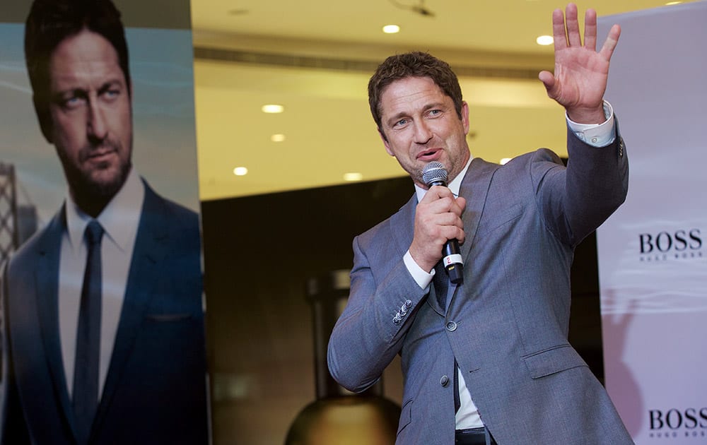 Scottish actor Gerard Butler waves at fans as he makes an appearance for Hugo Boss at the Paris Gallery in Dubai Mall, Dubai, United Arab Emirates.