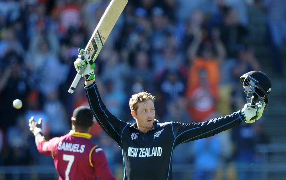 New Zealand’s Martin Guptill celebrates after scoring a century while batting against the West Indies during their Cricket World Cup quarterfinal match in Wellington, New Zealand.