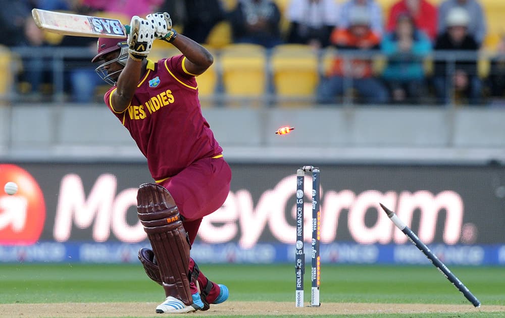 West Indies batsman Johnson Charles is bowled for three runs while batting against New Zealand during their Cricket World Cup quarterfinal match in Wellington, New Zealand.