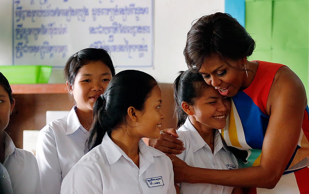US first lady Michelle Obama hugs Sohang Vean, a student at a local high school she was visiting, on the outskirts of Siem Reap, Cambodia. Mrs. Obama is in Cambodia to promote the education initiative 'Let Girls Learn,' which was launched to lift barriers that block more than 62 million girls around the world from attending school.