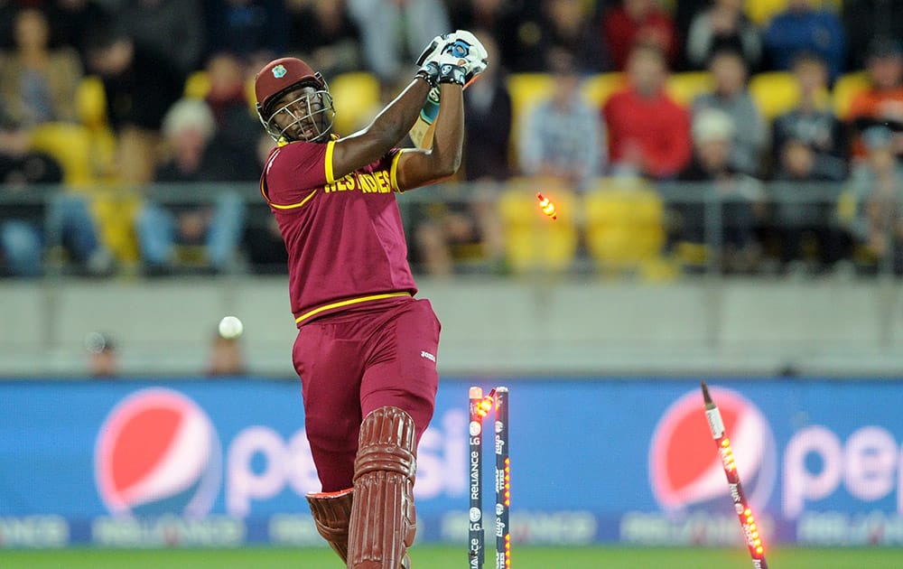 West Indies batsman Andre Russell is bowled out for 20 runs while batting against New Zealand during their Cricket World Cup quarterfinal match in Wellington, New Zealand.