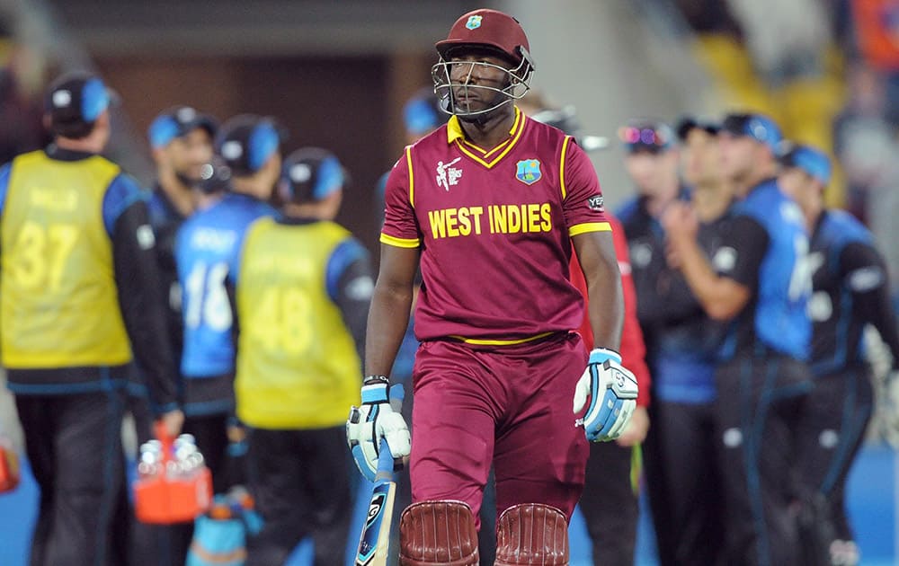 West Indies Andre Russell walks from the filed after he was bowled out for 20 runs while batting against New Zealand during their Cricket World Cup quarterfinal match in Wellington.