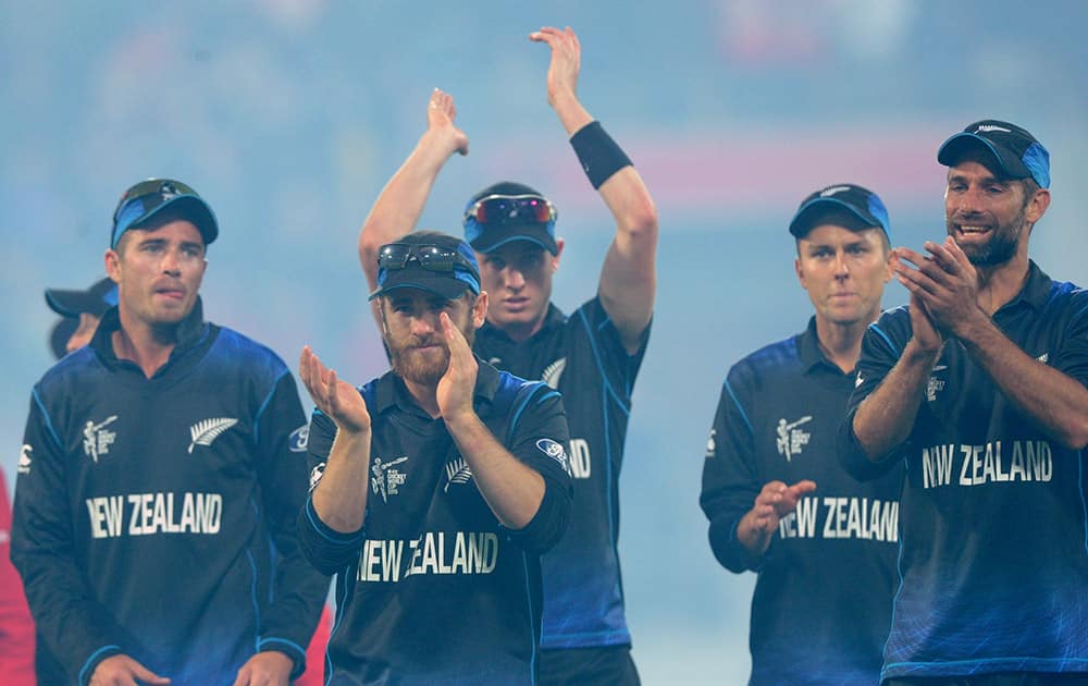 Members of the New Zealand team leave the field after defeating the West Indies by 143 runs during their Cricket World Cup quarterfinal match in Wellington.