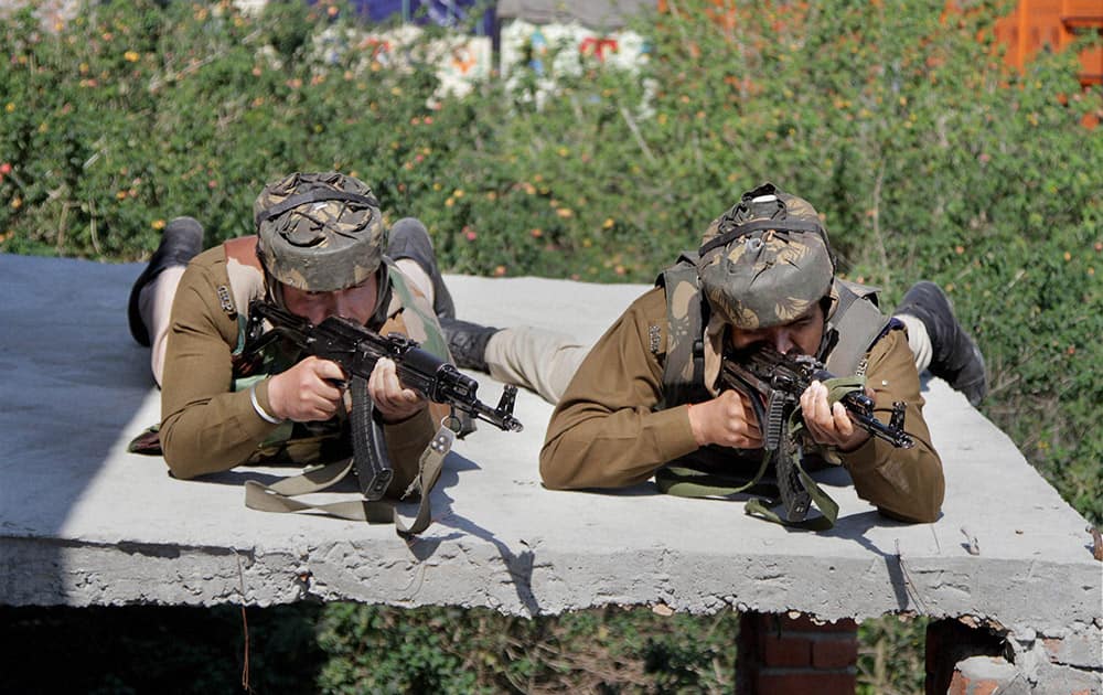 Security personnel take up positions during an encounter with militants at Mehasar army camp in Samba district of Jammu and Kashmir.