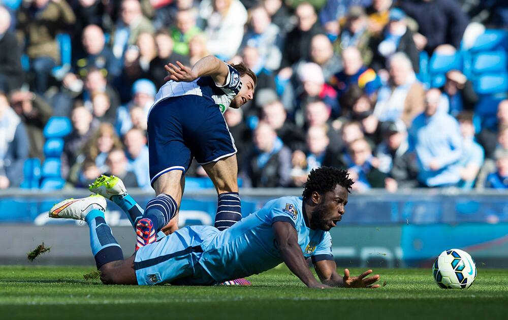 Manchester City's Wilfried Bony is brought down by West Bromwich Albion's Craig Dawson during the English Premier League soccer match between Manchester City and West Bromwich Albion at the Etihad Stadium, Manchester, England.