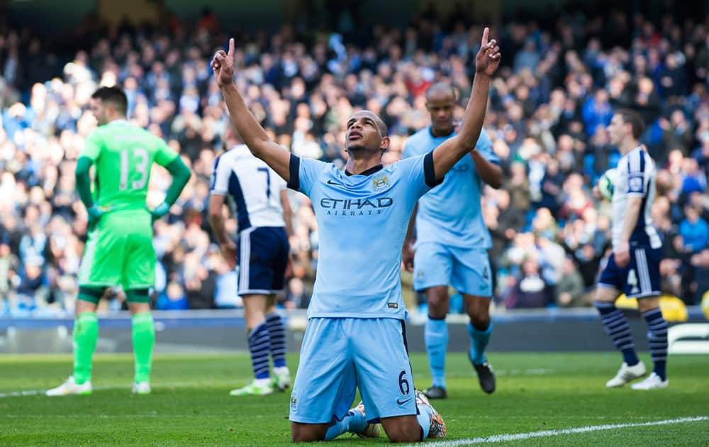 Manchester City's Fernando, centre, celebrates after scoring against West Bromwich Albion during the English Premier League soccer match between Manchester City and West Bromwich Albion at the Etihad Stadium, Manchester, England.