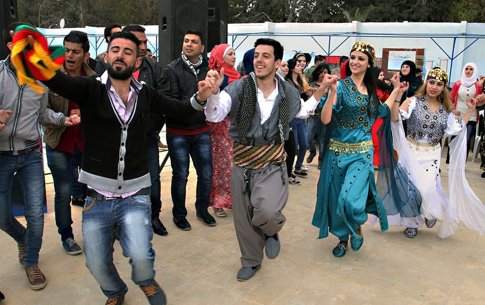 Syrian Kurds dance to celebrate Nowruz, the Kurdish new year, in Damascus, Syria.