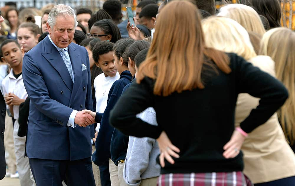 Britain's Prince Charles is greeted by a group of schoolchildren on his arrival at the Kentucky Center for African American Heritage in Louisville, Ky.