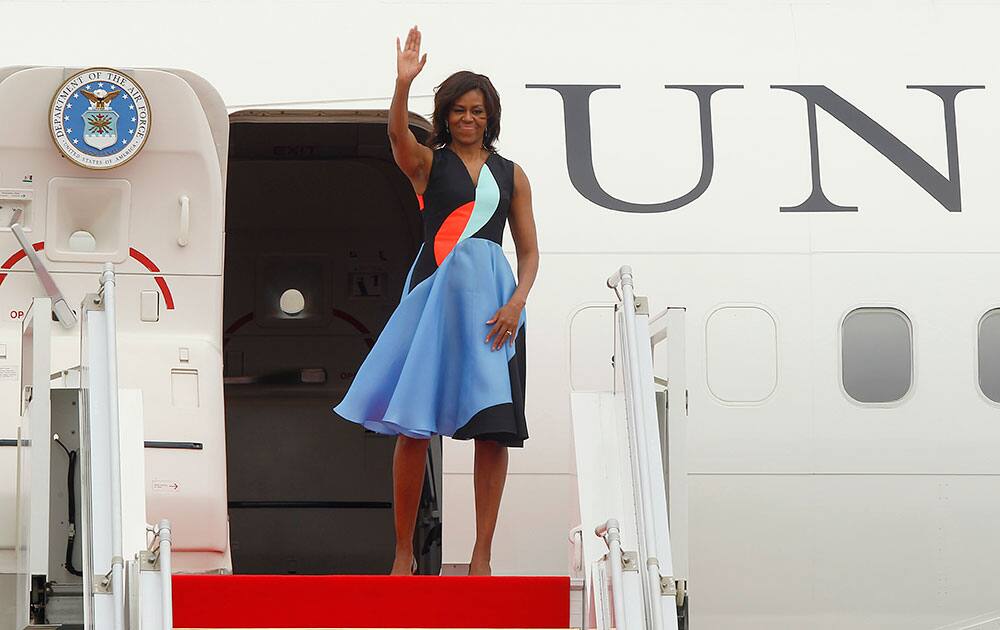 US first lady Michelle Obama waves as she leaves Siem Reap International Airport, Sunday, in Siem Reap, Cambodia. 