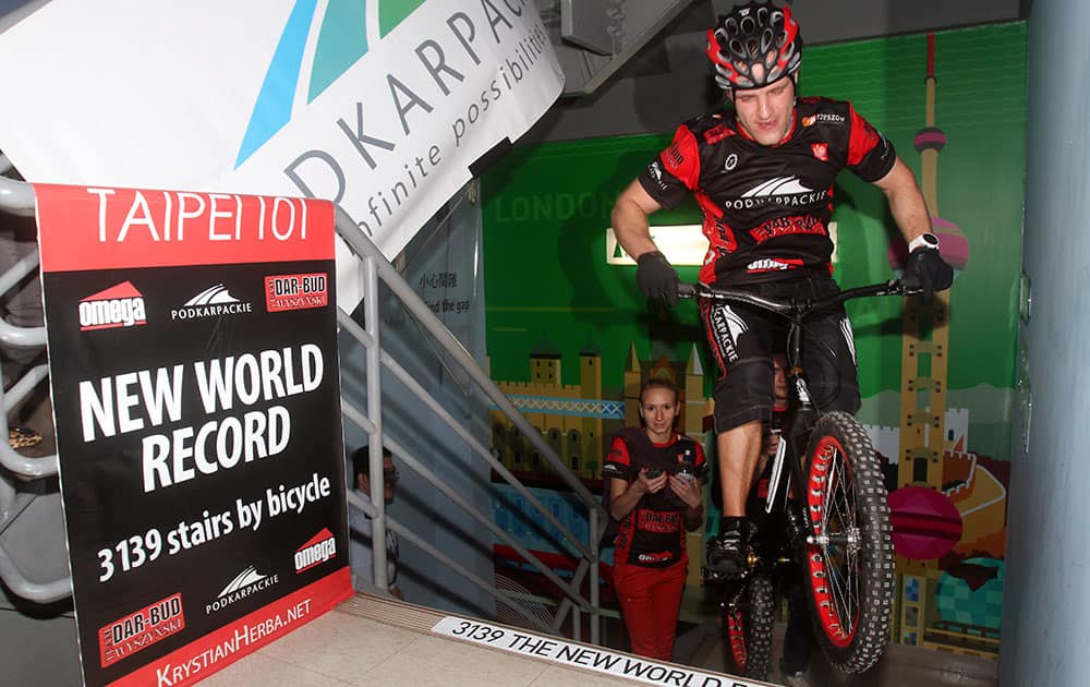 Poland's extreme cyclist Krystian Herba makes the final hop to climb up 3,139 stairs of Taipei's landmark tower building Taipei 101 in Taiwan by bicycle in 2 hours 13 minutes in his attempt to break his own Guinness World Record for most stairs climbed by bicycle.