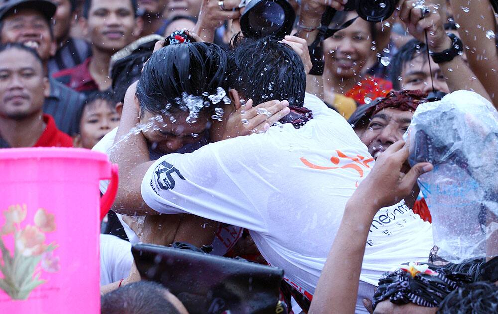 A Balinese couple embraces during the 