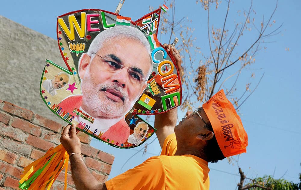 A kite maker showing a kite, emboldened with photograph of Prime Minister Narendra Modi, ahead of the latters arrival in Amritsar on Monday. 