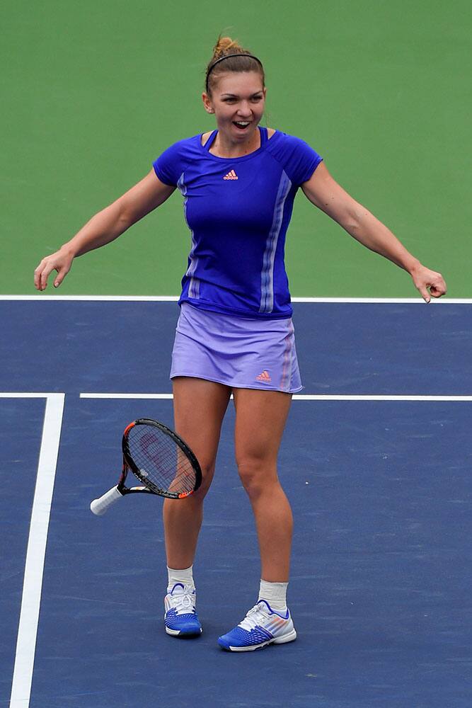 Simona Halep, of Romania, celebrates her win over Jelena Jankovic, of Serbia, during their final match at the BNP Paribas Open tennis tournament.