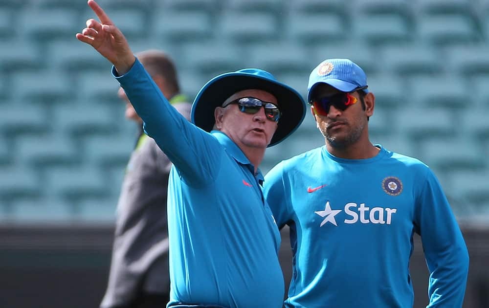 India's cricket captain MS Dhoni, right, talks with head coach Duncan Fletcher as his team arrives to train for their Cricket World Cup semifinal match in Sydney, Australia.