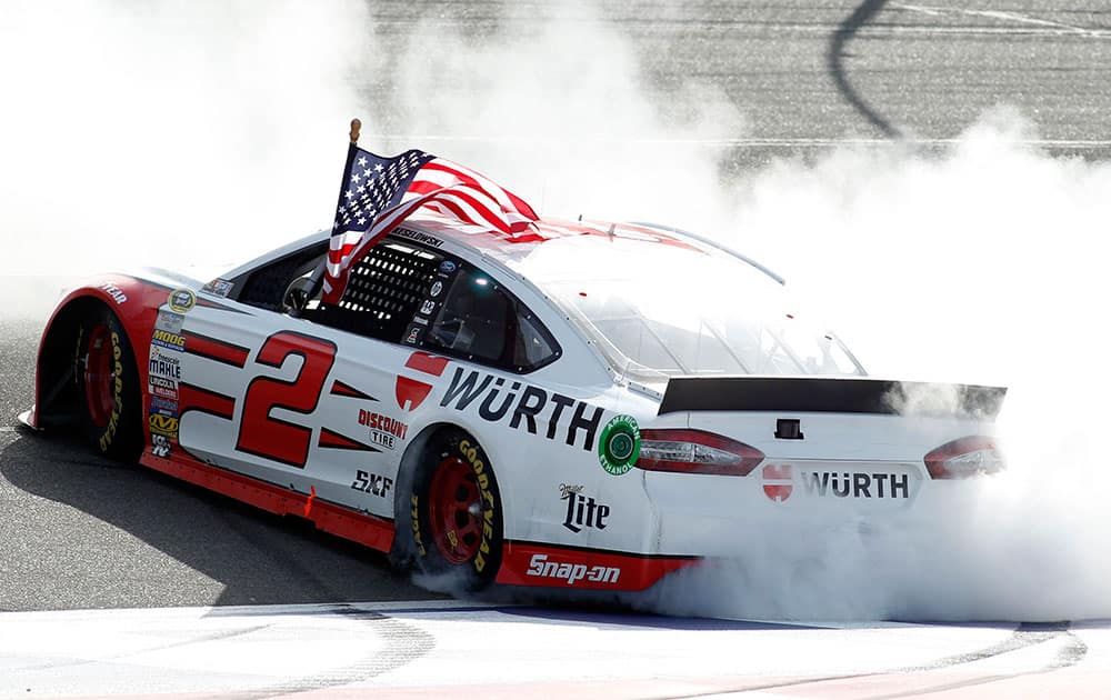 Brad Keselowski celebrates after winning the NASCAR Sprint Cup Series auto race in Fontana, Calif.