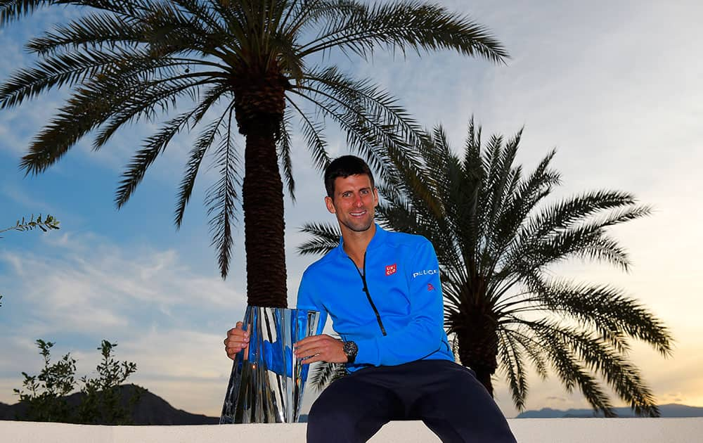 Novak Djokovic, of Serbia, poses with his trophy after his 6-3, 6-7 (5), 6-2 win over Roger Federer, of Switzerland, in the men's final of the BNP Paribas Open tennis tournament.