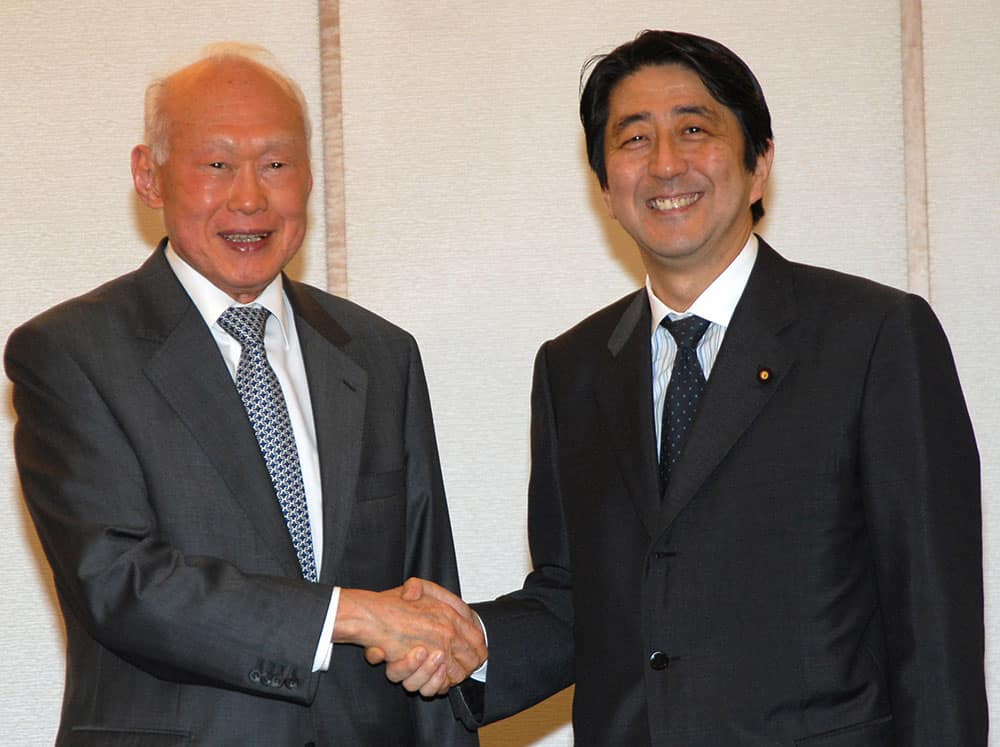 FILE - In this May 24, 2006, file photo, Singapore's then Minister Mentor Lee Kuan Yew, left, shakes hands with then Japanese Chief Cabinet Secretary Shinzo Abe prior to their meeting in Tokyo. 