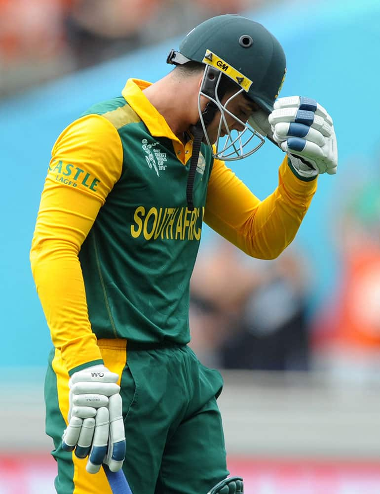 South African batsman Quinton De Kock walks from the field after he was dismissed for 14 runs during their Cricket World Cup semifinal against New Zealand in Auckland, New Zealand.